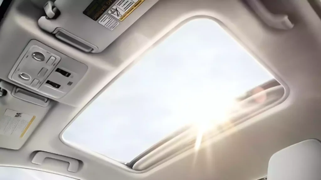 Close-up of a car's sunroof with a view of the sky
